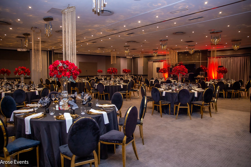 Elegant candlelit banquet hall setting by Arose Events